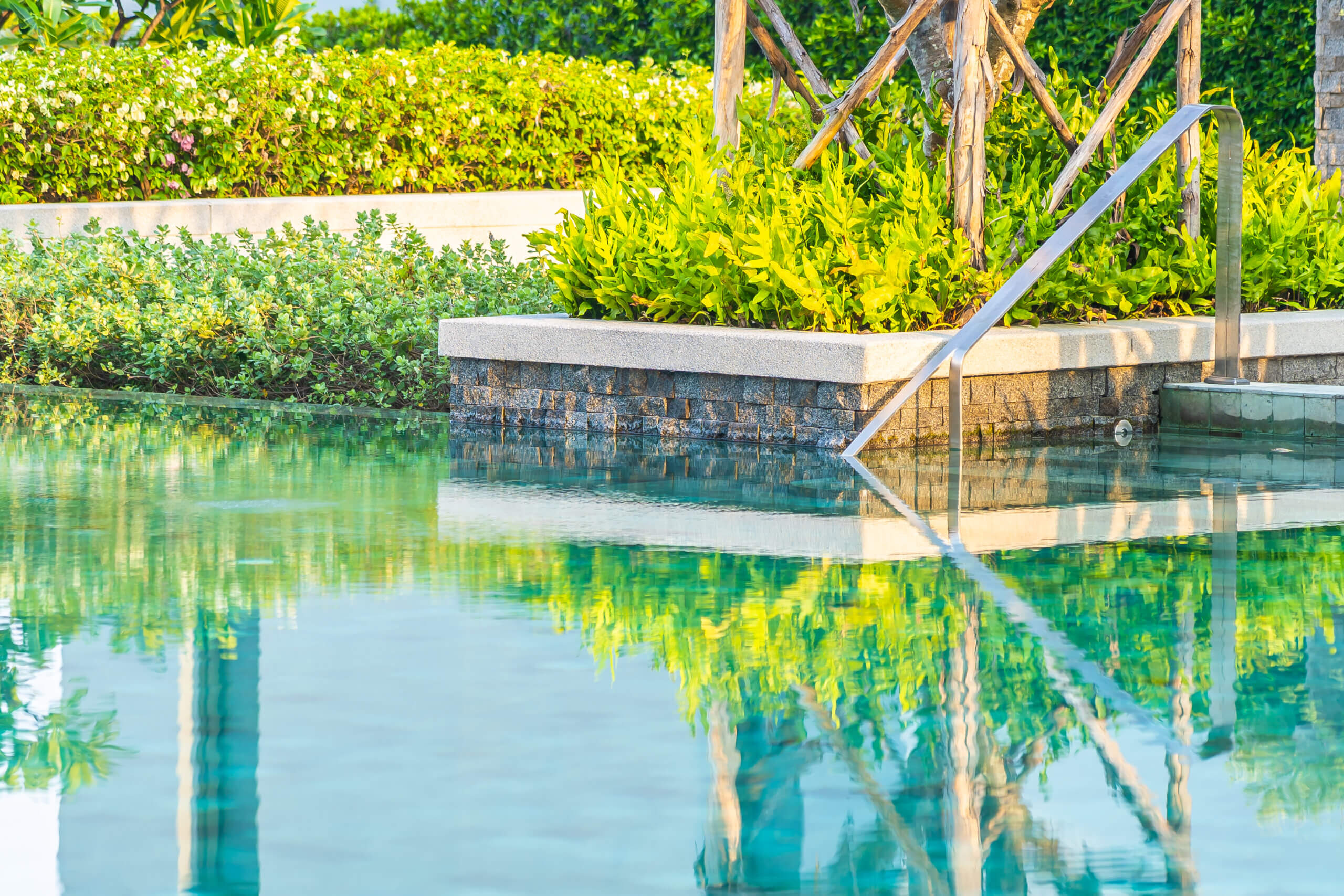 Outdoor swimming pool with umbrella chair lounge around there fo